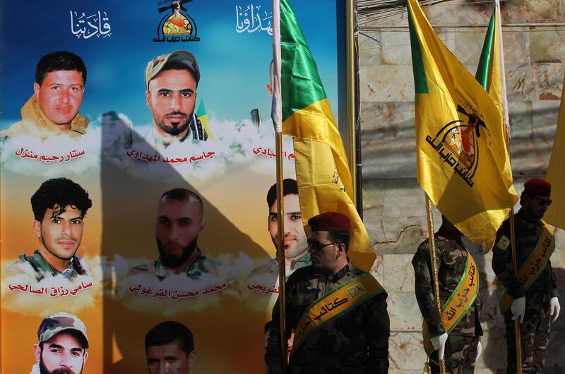 Members of the Iraqi Hezbollah Brigades, part of the Hashed al-Shaabi paramilitary units, carry flags in front of portraits of fellow members who were killed in air raids 4 days earlier, during a memorial ceremony in Baghdad on June 21, 2018.  The air strike that hit targets in eastern Syria near the frontier with Iraq where forces on the ground are battling Islamic State Group (IS) remnants, reportedly left more than 50 people dead, state media and a Britain-based monitor said.
Both Damascus and the Iran backed-Hashed have blamed the US-led coalition for the raids, but the coalition and the Pentagon denied any involvement.


 / AFP / AHMAD AL-RUBAYE
