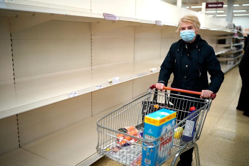 Senior citizens walk past empty shelves as they shop at Sainsbury's Supermarket in Northwich. Getty Images