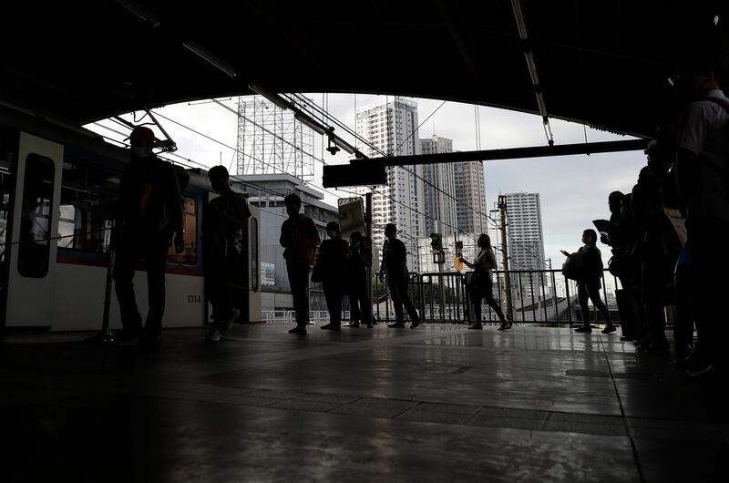 People board a train. AP Photo