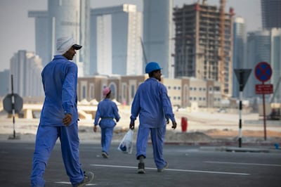 Abu Dhabi, UNITED ARAB EMIRATES, June 22, 2014:  
Laborers rush toward their bus at the end of their shift, near new construction projects on Reem Island in Abu Dhabi as seen on Sunday, June 22, 2014.
(Silvia Razgova / The National)

Reporter: standalone 
Section: NA, BIZ
Usage: stock
