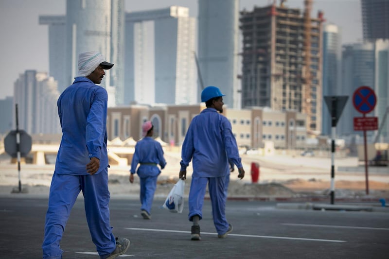 Abu Dhabi, UNITED ARAB EMIRATES, June 22, 2014:  
Laborers rush toward their bus at the end of their shift, near new construction projects on Reem Island in Abu Dhabi as seen on Sunday, June 22, 2014.
(Silvia Razgova / The National)

Reporter: standalone 
Section: NA, BIZ
Usage: stock
