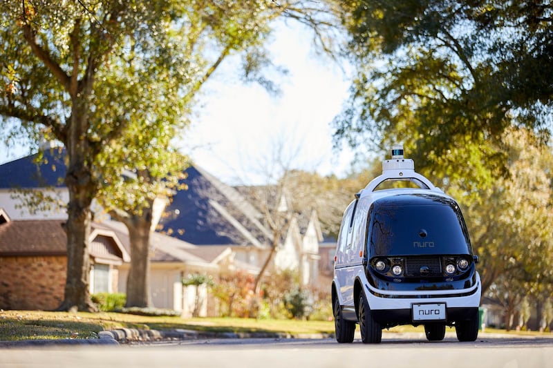 This undated image provided by Nuro in February 2020 shows their self-driving vehicle "R2" on a neighborhood street. On Thursday, Feb. 6, 2020, the U.S. National Highway Traffic Safety Administration granted temporary approval for Silicon Valley robotics company Nuro to the a low-speed autonomous delivery vehicle, without side and rear-view mirrors and other safety provisions required of vehicles driven by humans. (Nuro via AP)