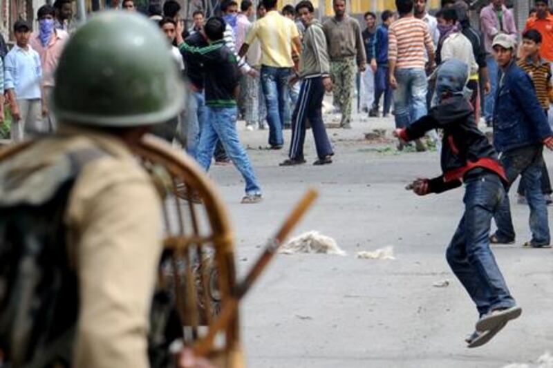 Kashmiri protesters throw stones at Indian paramilitary troops during a protest in the city of Srinagar. Rouf Bhat / AFP