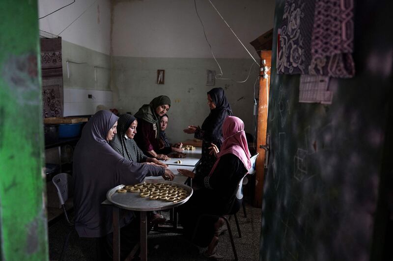 Palestinian women in central Gaza prepare traditional cookies for Eid Al Fitr, which marks the end of Ramadan. AFP