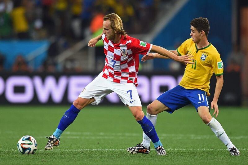 Ivan Rakitic of Croatia holds off Oscar of Brazil during their opening match at the 2014 World Cup on Thursday. Christopher Lee / Getty Images / June 12, 2014  