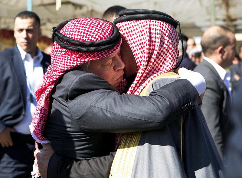 King Abdullah II of Jordan embraces Safi Al Kassasbeh, the father of executed Jordanian pilot Maaz Al Kassasbeh in Ai village yesterday. EPA 
