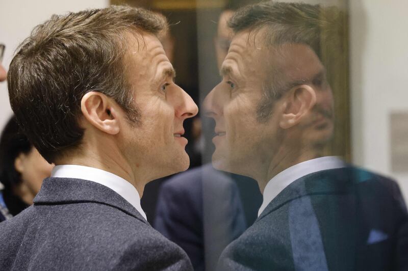 French President Emmanuel Macron is reflected as he looks at paintings at the National Gallery in Prague. AFP