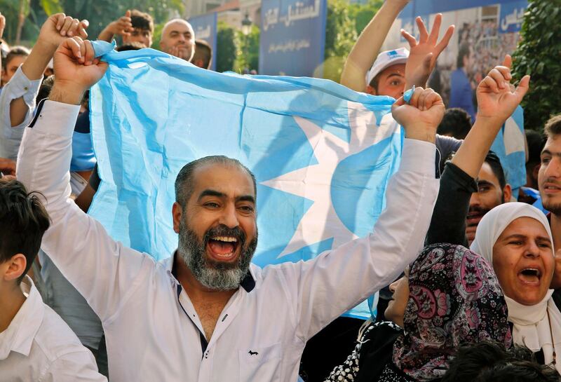 Supporters of Lebanese Prime Minister Saad Hariri, chant slogans during a celebration after Hariri's bloc won 21 seats in the parliamentary elections, paving the way for him to be named the next premier, at his house in downtown Beirut, Lebanon, Friday, May 11, 2018. (AP Photo/Bilal Hussein)