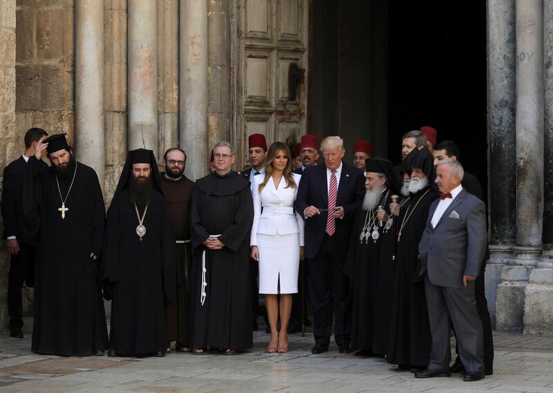 FILE PHOTO: U.S. President Donald Trump (C) and first lady Melania stand at the entrance of the Church of the Holy Sepulchre in Jerusalem's Old City May 22, 2017. REUTERS/Ronen Zvulun/File Photo