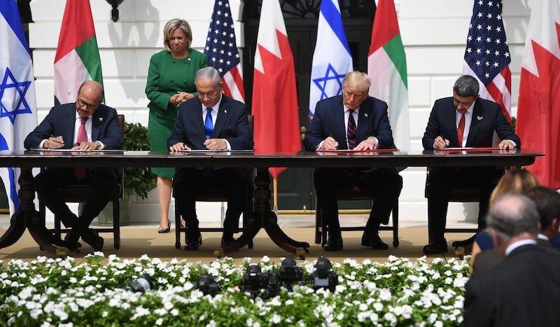 Sheikh Abdullah and, from left, Mr Al Zayani, Mr Netanyahu and Mr Trump sign the Abraham Accord. AFP