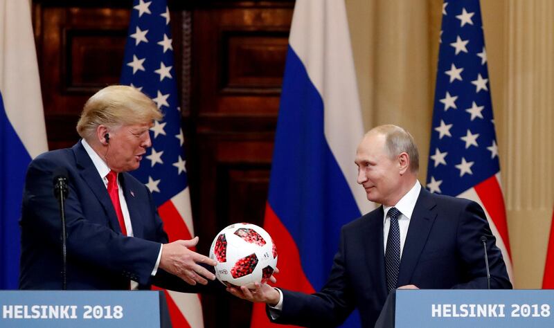 FILE PHOTO: U.S. President Donald Trump receives a football from Russian President Vladimir Putin as they hold a joint news conference after their meeting in Helsinki, Finland July 16, 2018. REUTERS/Grigory Dukor/File Photo