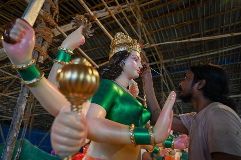 An artist in Mumbai reviews his work on the idol of Hindu goddess Durga ahead of the festival beginning this week. AFP