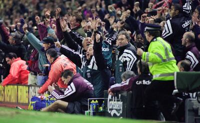 LIVERPOOL, UNITED KINGDOM - APRIL 03:  Liverpool manager Roy Evans (arms aloft) and coach Ronnie Moran (behind Evans) celebrate Stan Collymore's stoppage time winner as Newcastle player Steve Howey (sitting on floor) and management duo Kevin Keegan and Terry McDermott (behind Carlsberg sign) react during the Premier League match between Liverpool and Newcastle United at Anfield on April 3, 1996 in Liverpool, England.  (Photo by Stu Forster/Allsport/Getty Images)