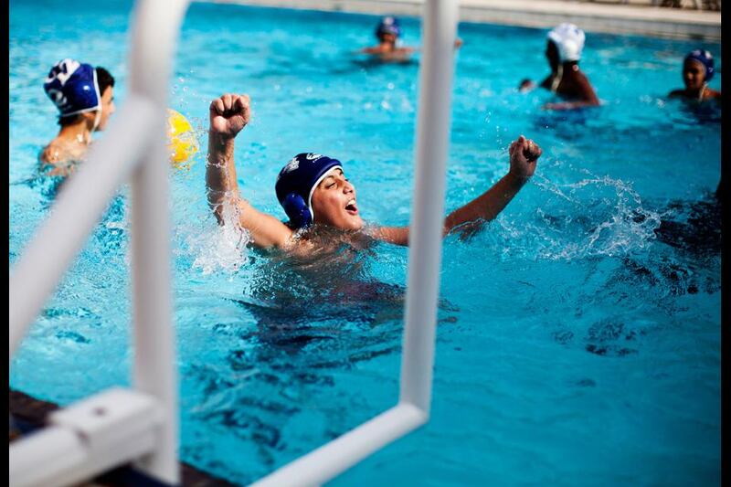 Ruwais, United Arab Emirates - July 15  2012 - One of the boys enrolled in a 45 day summer camp cheers because he has blocked a goal while playing water-polo at the Ruwais Recreation Center. Most of the young teenagers enrolled in the summer camp live in Ruwais full-time as their parents work in ADCO, ADNOC, GASCO, Takreer, FERTIL or BOROUGE.  (Razan Alzayani / The National) tags:  FOCAL POINT