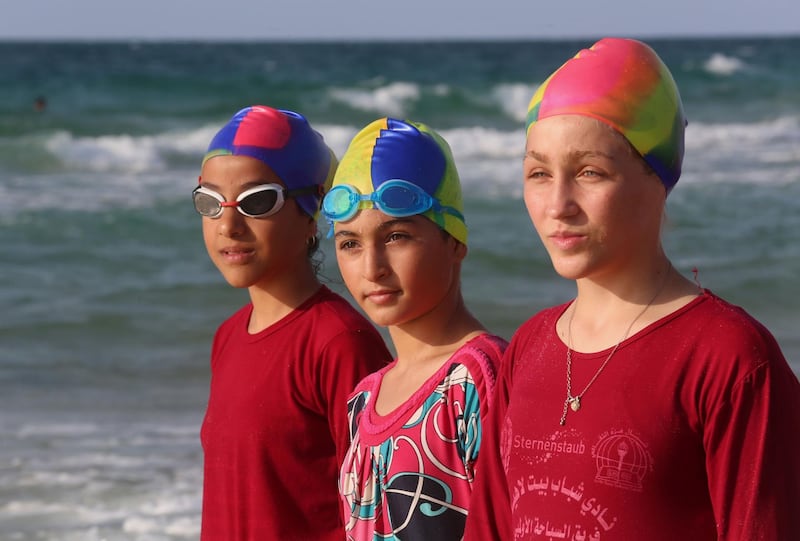 Young Palestinian members of a swimming club, prepare to swim during training session in Beit Lahia in the northern Gaza Strip, on October 4, 2018. On one of the world's most polluted beaches, 30 young Palestinians dive head first into the sea off the coast of Gaza, their minds filled with dreams of Olympic glory. 
Aged between 11 and 16, they make up a rare swimming club in the Gaza Strip, and perhaps its only mixed-sex one.
 / AFP / SAID KHATIB
