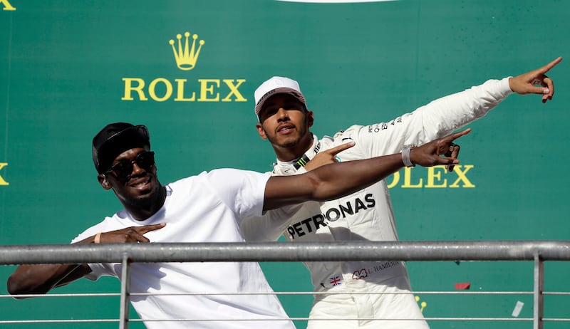 Usain Bolt shows Mercedes driver Lewis Hamilton how to celebrate a victory. Tony Gutierrez / AP Photo