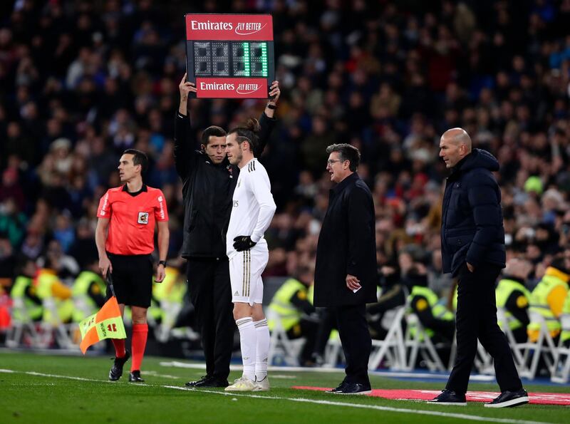 Bale prepares to come on as a sub, a move greeted with whistles and jeers from the crowd. AP