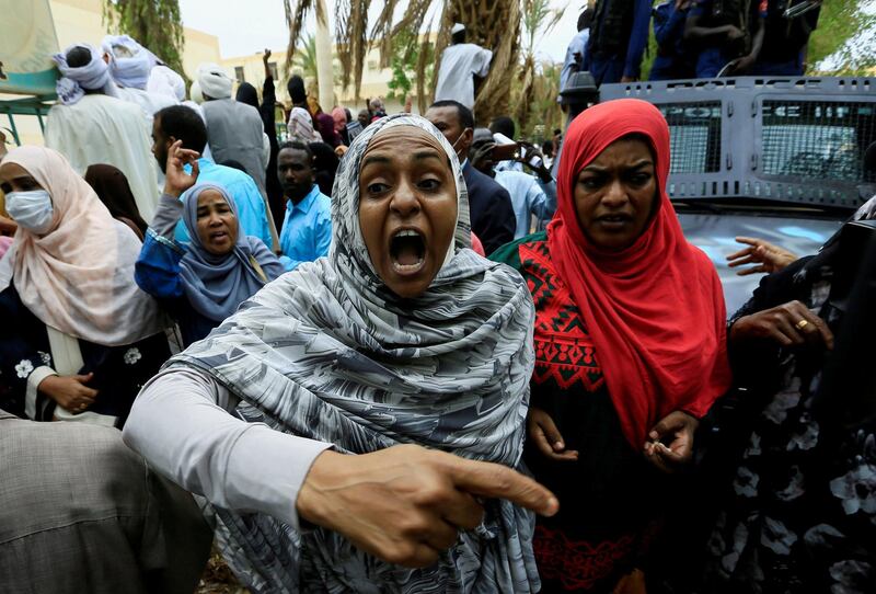 A Sudanese woman chants slogans outside the court during the new trial against ousted President Omar al-Bashir and some of his former allies on charges of leading a military coup that brought the autocrat to power in 1989 in Khartoum, Sudan. REUTERS