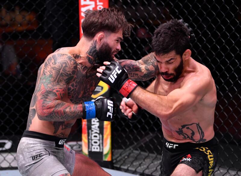 Cody Garbrandt punches Raphael Assuncao in their bantamweight bout during UFC 250. Reuters