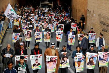 Demonstrators from the southern Iraqi city of Nassiriyah march with pictures of people killed during anti-government protests. Reuters