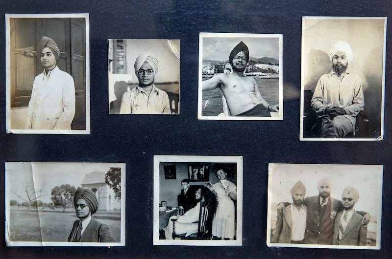 Photographs of Narindra Singh Pujji decorate a wall in his Dubai home, looking back at his days as a student in Pakistan and Delhi in the 1940s. Victor Besa / The National
