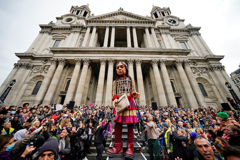 Little Amal is greeted by crowds after arriving at St Paul's Cathedral, in London. AP Photo