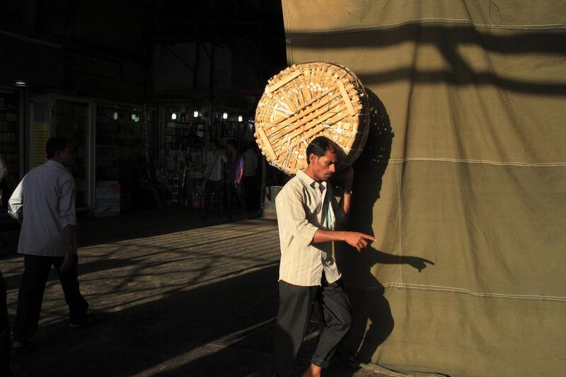 A porter carries an item for a client at Crawford Market. Subhash Sharma for The National