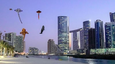 People connect with the coastline on Reem Island in Abu Dhabi. Victor Besa / The National 