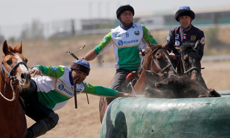 Uzbek and French horsemen take part in kok-boru. EPA