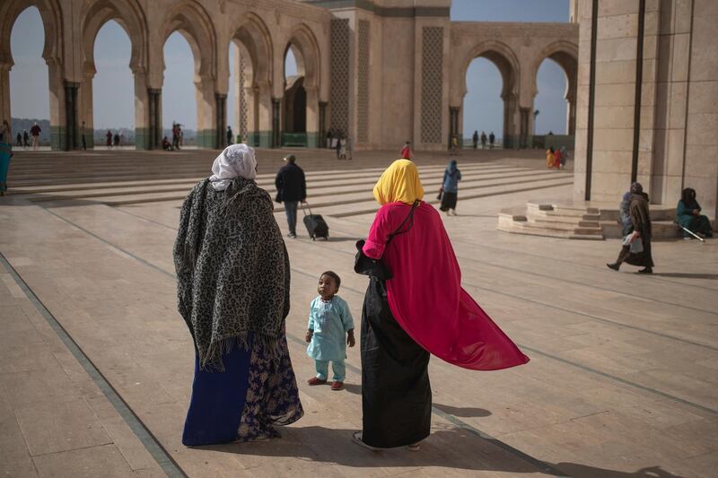 A Muslim family walks after performing Friday prayers outside the mosque of Hassan II, one of the largest in Africa, in Casablanca, Morocco. AP Photo