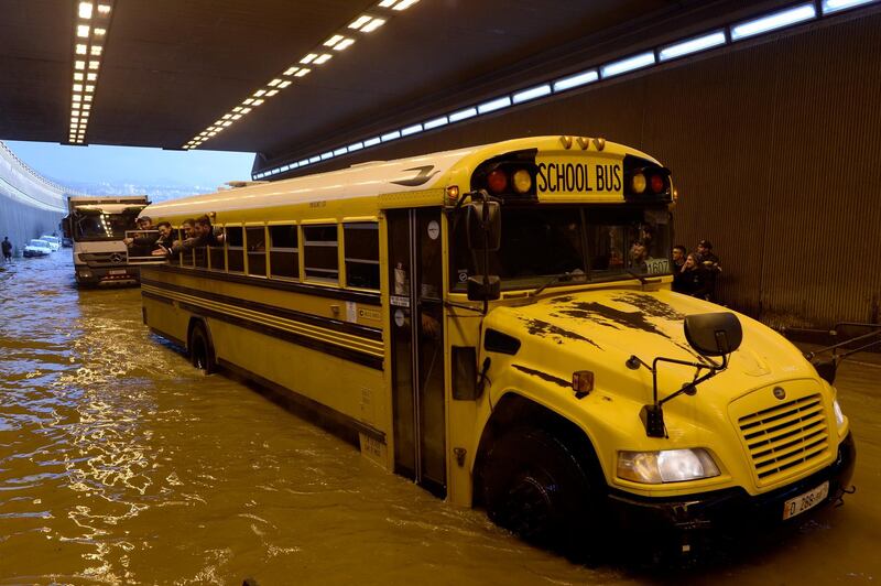 A school bus drives through a flooded tunnel after a heavy downpour near Rafic Hariri International Airport at the southern entrance of Beirut.  EPA