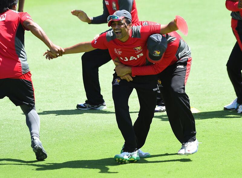 UAE's Khurram Khan, centre, loses his glasses as he competes during a final training session ahead of their Pool B 2015 Cricket World Cup match against India, in Perth on February 27, 2015. AFP PHOTO / Greg WOOD