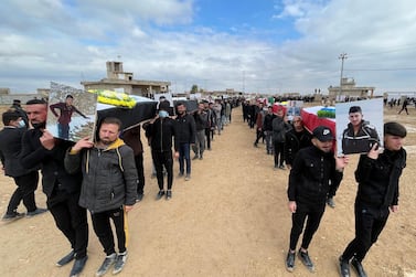 Mourners carry coffins of Yazidis from the village of Kocho who were killed by ISIS in August 2014. Their remains were exhumed from mass graves and buried near the village on February 6, 2021. Reuters