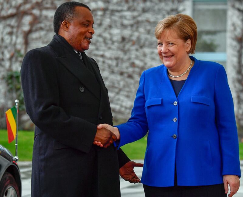 German Chancellor Angela Merkel greets Congolese President Denis Sassou Nguesso upon his arrival to attend the peace summit on Libya at the Chancellery in Berlin. AFP