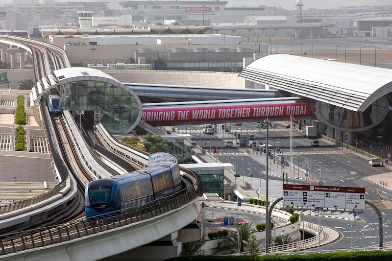 An airport access train departs the arrivals hall in Terminal Three at Dubai International Airport.