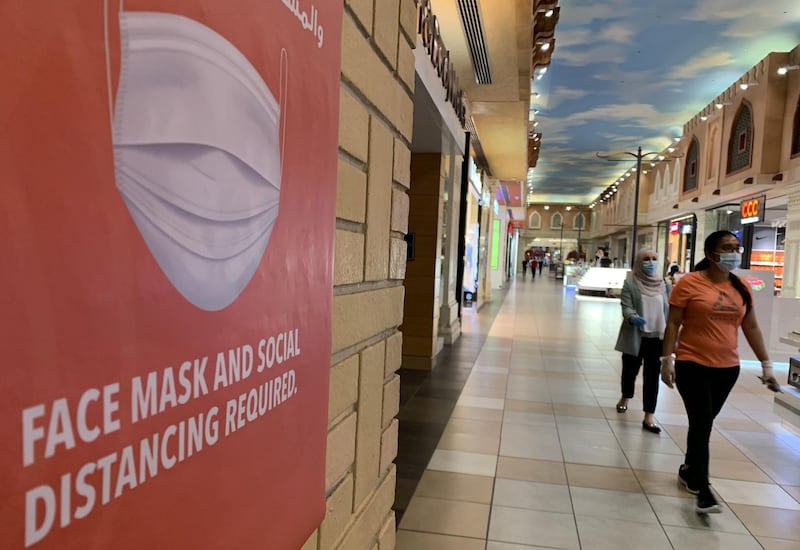 People, wearing protective masks to prevent the spread of the coronavirus, walk in Ibn Battuta Mall in Dubai. AFP