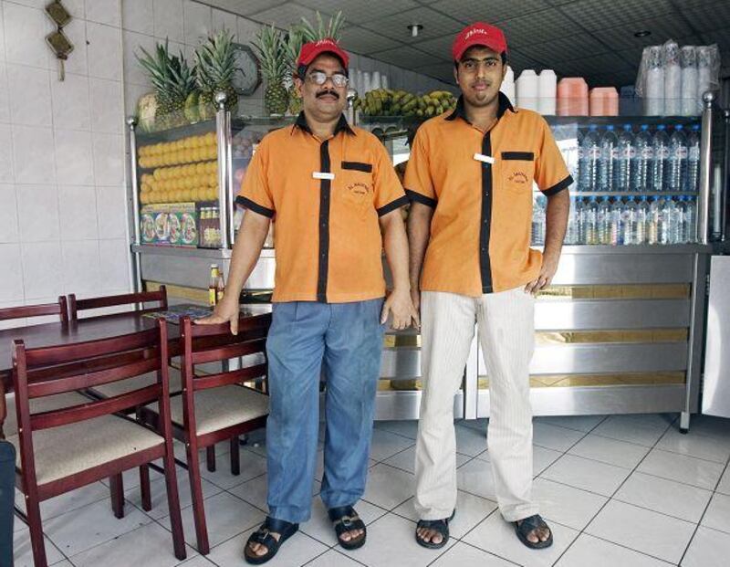 Aboobacker Ebrahim, left, and Haris Pallikal in uniform in the Al Mazhariah Cafeteria in Sharjah.