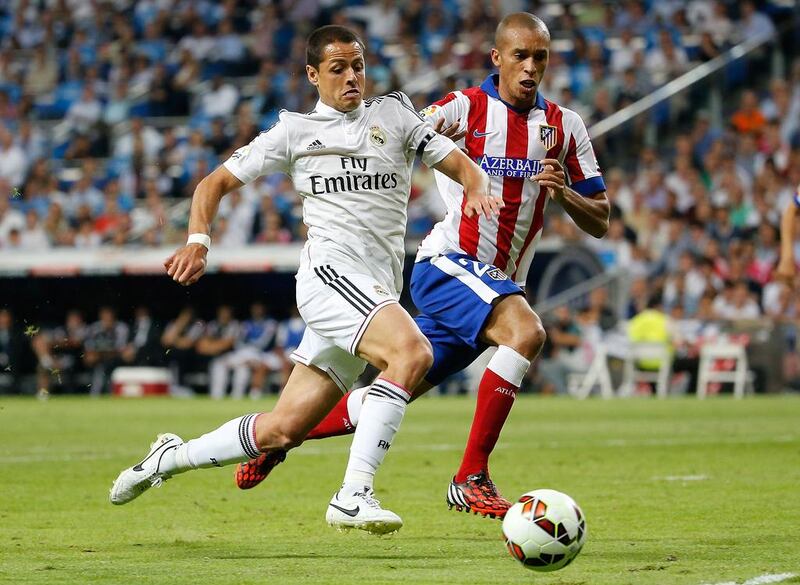 Javier Hernandez, left, of Real Madrid competes for the ball with Joao Miranda of Atletico Madrid during the Spanish Primera Liga match at Estadio Santiago Bernabeu on September 13, 2014, in Madrid, Spain. Angel Martinez / Getty Images