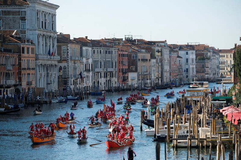 Rowers dressed as Father Christmas take part in a Christmas regatta along the Grand Canal in Venice, Italy. Reuters