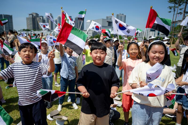 Children wave the UAE and South Korean flags. Mohamed Al Hammadi / UAE Presidential Court 
