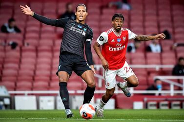 epa08548422 Liverpool's Virgil van Dijk (L) in action against Arsenal's Reiss Nelson (R) during the English Premier League soccer match between Arsenal London and Liverpool FC in London, Britain, 15 July 2020. EPA/Glyn Kirk/NMC/Pool EDITORIAL USE ONLY. No use with unauthorized audio, video, data, fixture lists, club/league logos or 'live' services. Online in-match use limited to 120 images, no video emulation. No use in betting, games or single club/league/player publications.