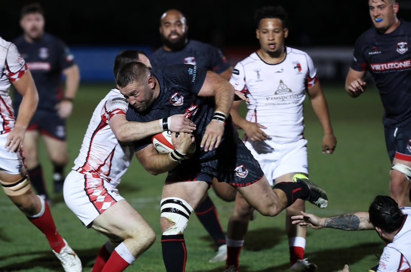 A Dubai Exiles player attempts to break through the Abu Dhabi Harlequins defence.
