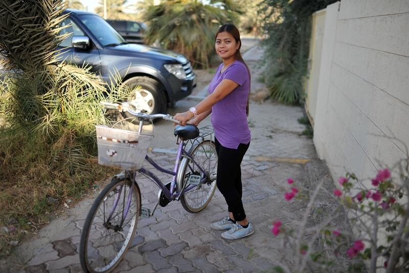Emy Penid cycles to work every day from her home off Airport Road, staying off the main roads and using quiet neighborhood streets instead. She says the journey takes her about 15 minutes. Delores Johnson / The National
