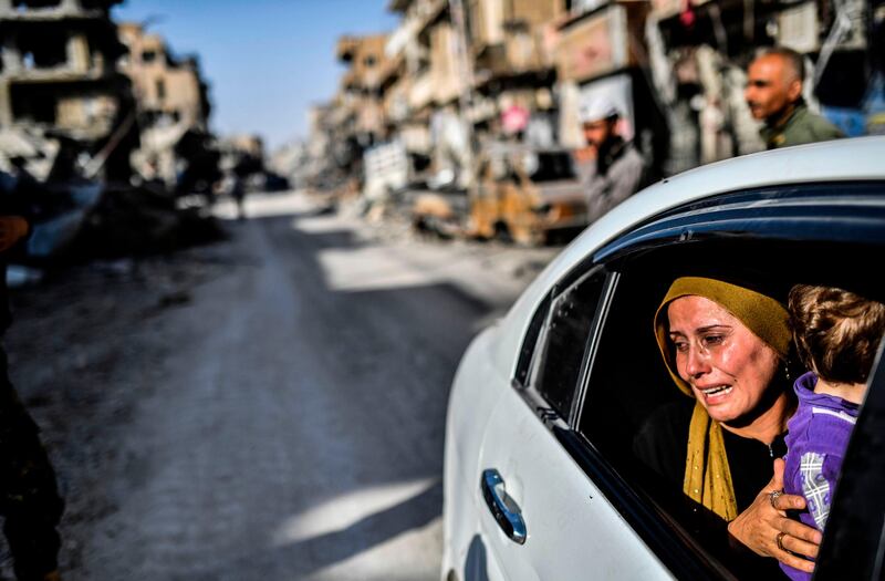 A woman cries as she looks at her house in Raqqa after a Kurdish-led force expelled ISIL from the northern Syrian city. Bulent Kilic / AFP