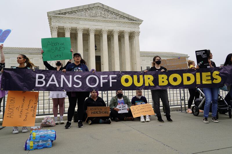 Pro-choice supporters pose in front of the US Supreme Court. Willy Lowry / The National