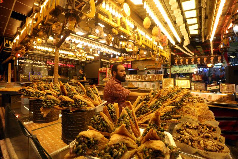 A seller arranges oriental sweets at his shop at Al Midan market in Damascus, Syria.