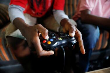 Udom Idongesit, 13, uses a gaming controller as he plays a Vikseen Virtual video game, in his home in Ogun State, Nigeria June 23, 2022.  REUTERS / Temilade Adelaja