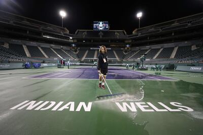 INDIAN WELLS, CALIFORNIA - MARCH 08: Courtmaster Jeffrey Brooker cleans the center court at the Indian Wells Tennis Garden on March 08, 2020 in Indian Wells, California. The BNP Paribas Open was cancelled by the Riverside County Public Health Department, as county officials declared a public health emergency when a case of coronavirus (COVID-19) was confirmed in the area.   Al Bello/Getty Images/AFP
== FOR NEWSPAPERS, INTERNET, TELCOS & TELEVISION USE ONLY ==
