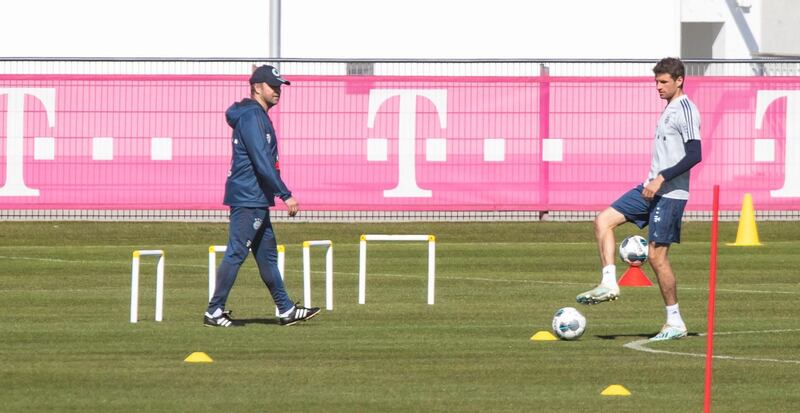 Bayern manager Hansi Flick, left, and Thomas Mueller during a training session as the team returned to training  for the first time since the Bundesliga campaign was halted by the coronavirus pandemic. EPA