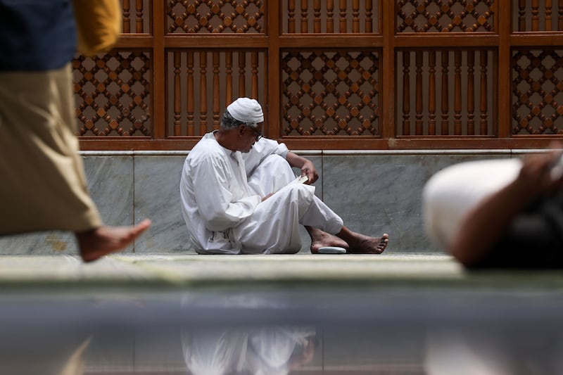 A worshipper reads the Quran at the Prophet's Mosque in Madinah. AFP